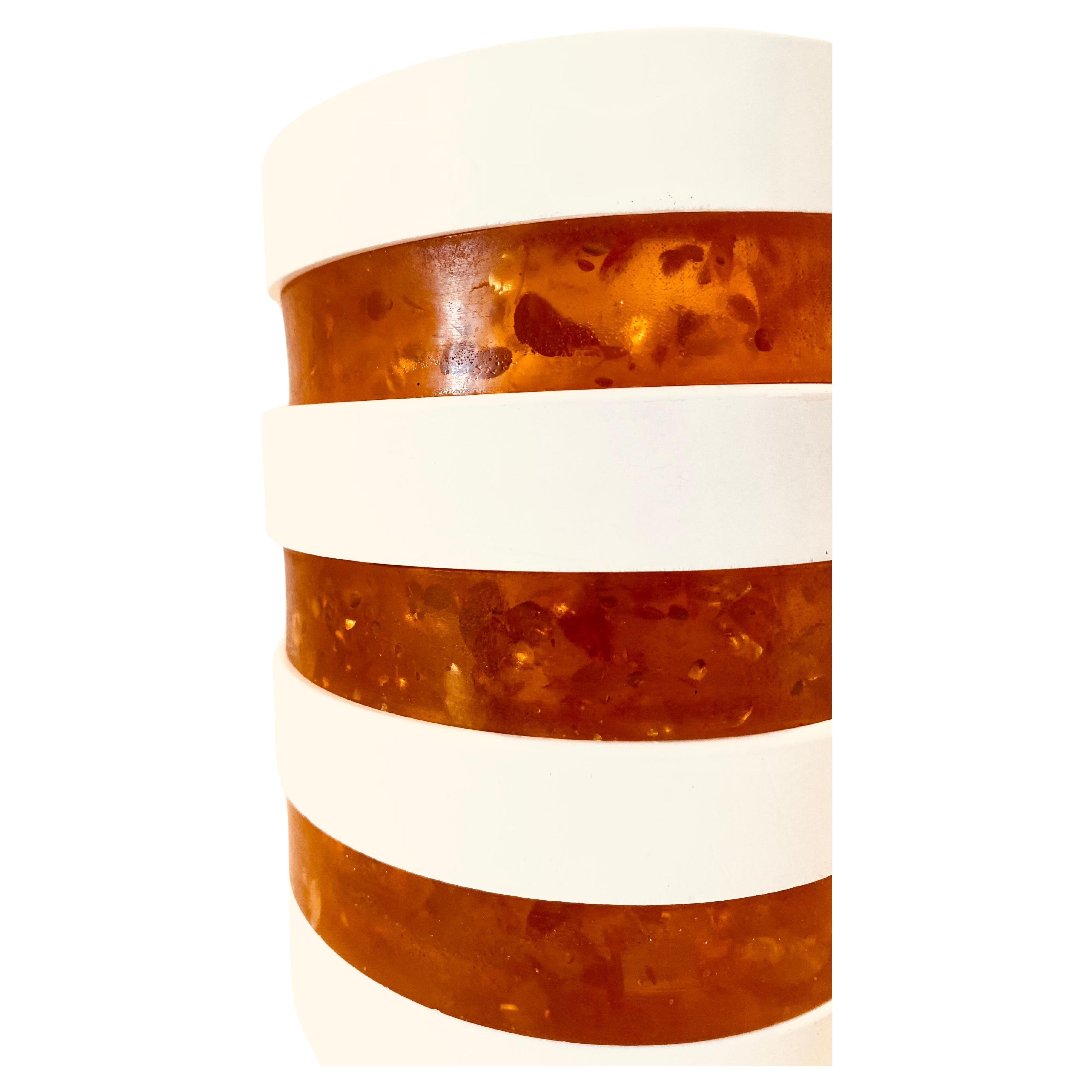 Lampe de table vintage de 1970 dans le style de l'âge de l'espace. Fabriquée en Italie, la lampe est composée de sept anneaux (quatre blancs et trois ambrés) et d'un abat-jour tubulaire en verre. Les anneaux peuvent être placés en fonction du goût