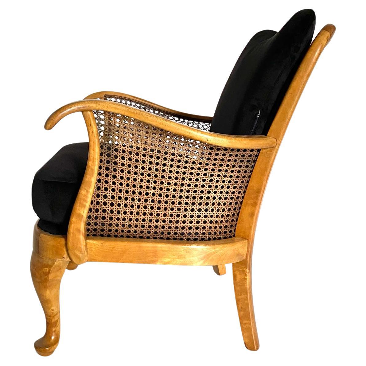 Rare classic art deco armchair produced in France in the 1930s. Beech bentwood frame with elegant cane on both the back seat and side sides. Black velvet upholstered seat and back cushions. Fully restored as follows: Beech wood has been treated,