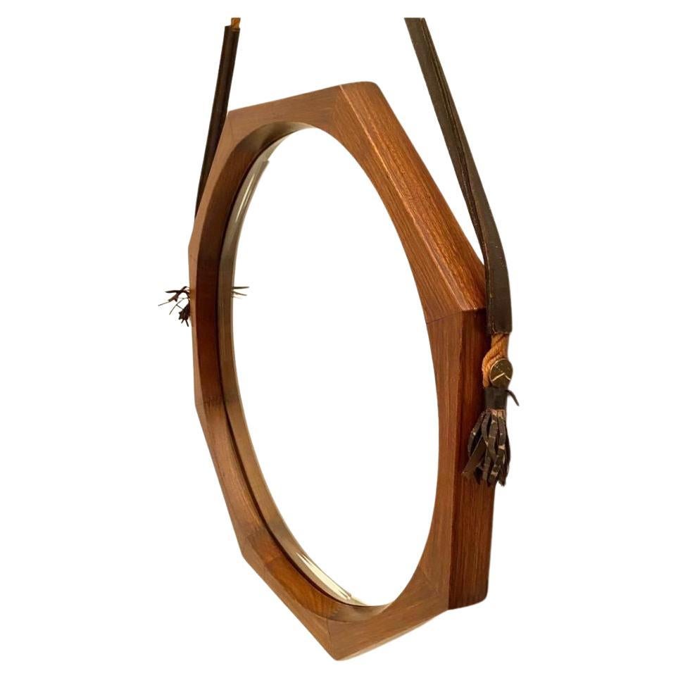 Vintage octagonal teak mirror manufactured in Italy in the 1960s and designed by Campo & Graffi.  Solid teak wood frame, hanging rope fixed at the frame thanks to a brass pivot. Beautifully worked beveled mirror.
All parts are the original ones.