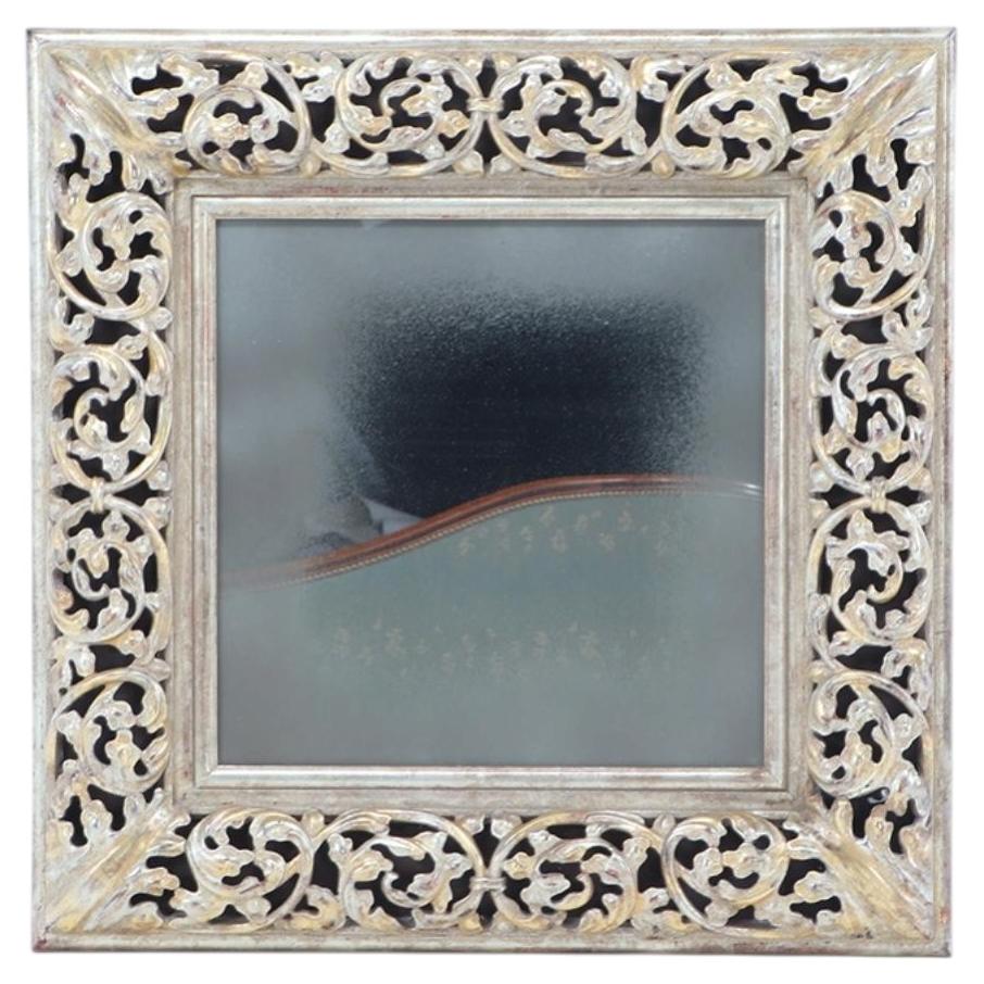 A silver gilt carved wood square mirror. For Sale