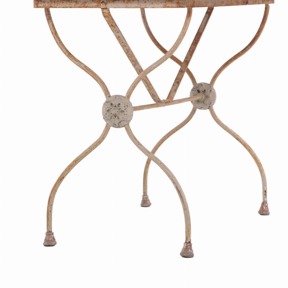 The zinc trim adds a utilitarian detail typical of French industrial design, while the crossed-leg iron base ensures stability and timeless charm. Ideal for use as a small dining table, café table, or accent piece in both indoor and outdoor settings.