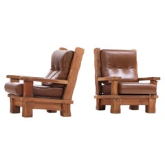 A Pair of French Heavy Oak Brutalist style Open Arm Chairs, C. 1960.