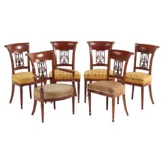 A Set of Six French Directoire Style Carved Walnut Dining Chairs, 19th Century.