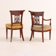 A Set of Six French Directoire Style Carved Walnut Dining Chairs, 19th Century.