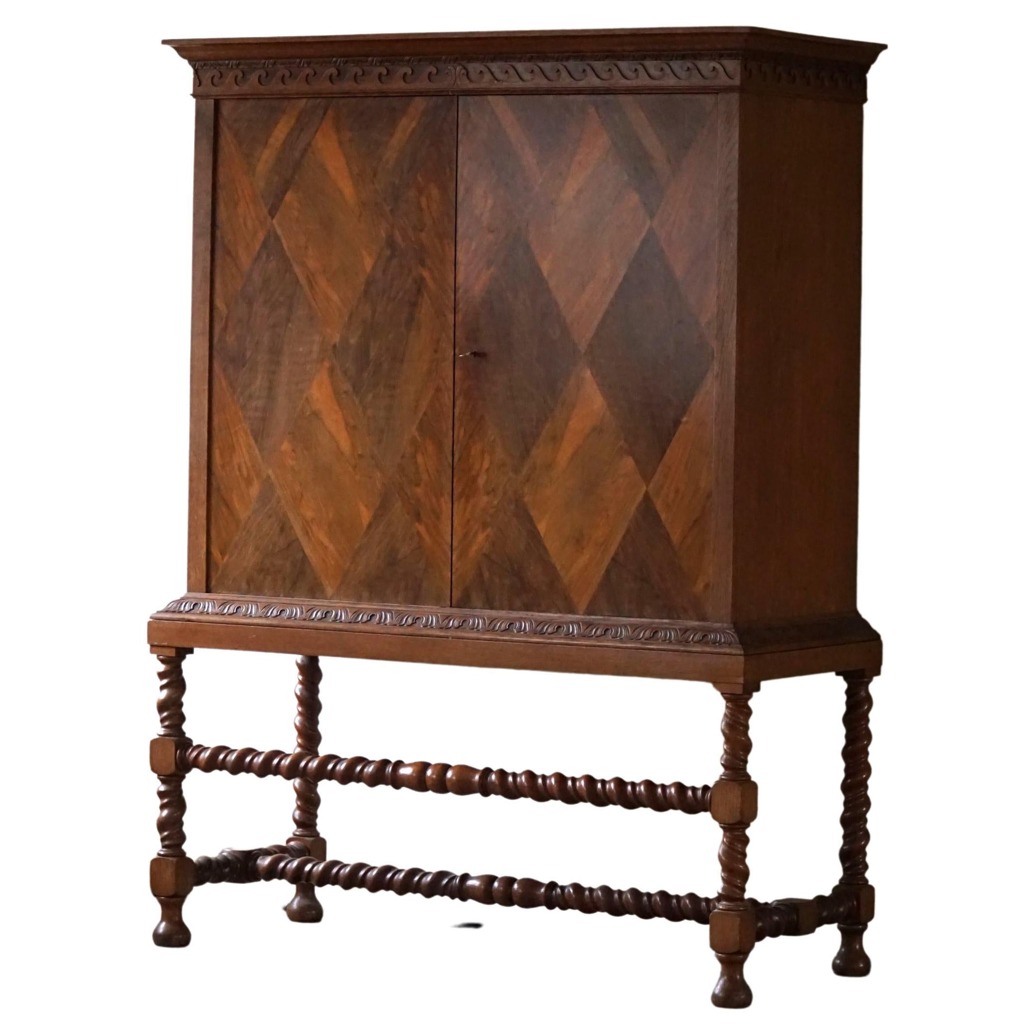 A very rare cabinet with twisted legs made in nutwood. Rich details such as a beautiful harlequin shaped front design. Designed by cabinetmaker Otto Meyer in 1926, Copenhagen, Denmark. 
Many other danish architects made their furnitures at