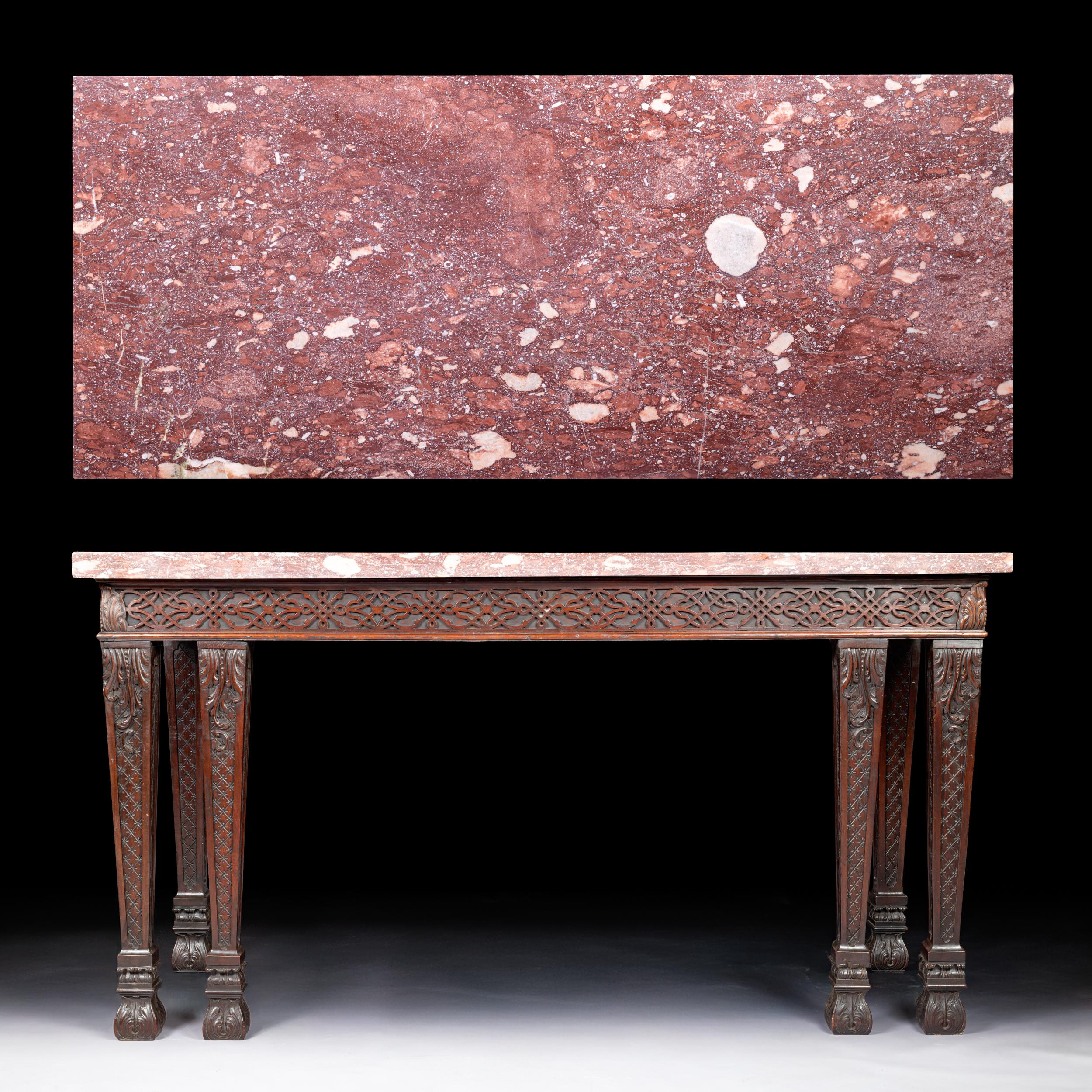 A fine Georgian console table / side table of rectangular form, the stunning marble featuring a beautifully figured Rosso Verona marble top resting on a finely carved base. The frieze is deeply pierced with an intricate foliate scrollwork design,