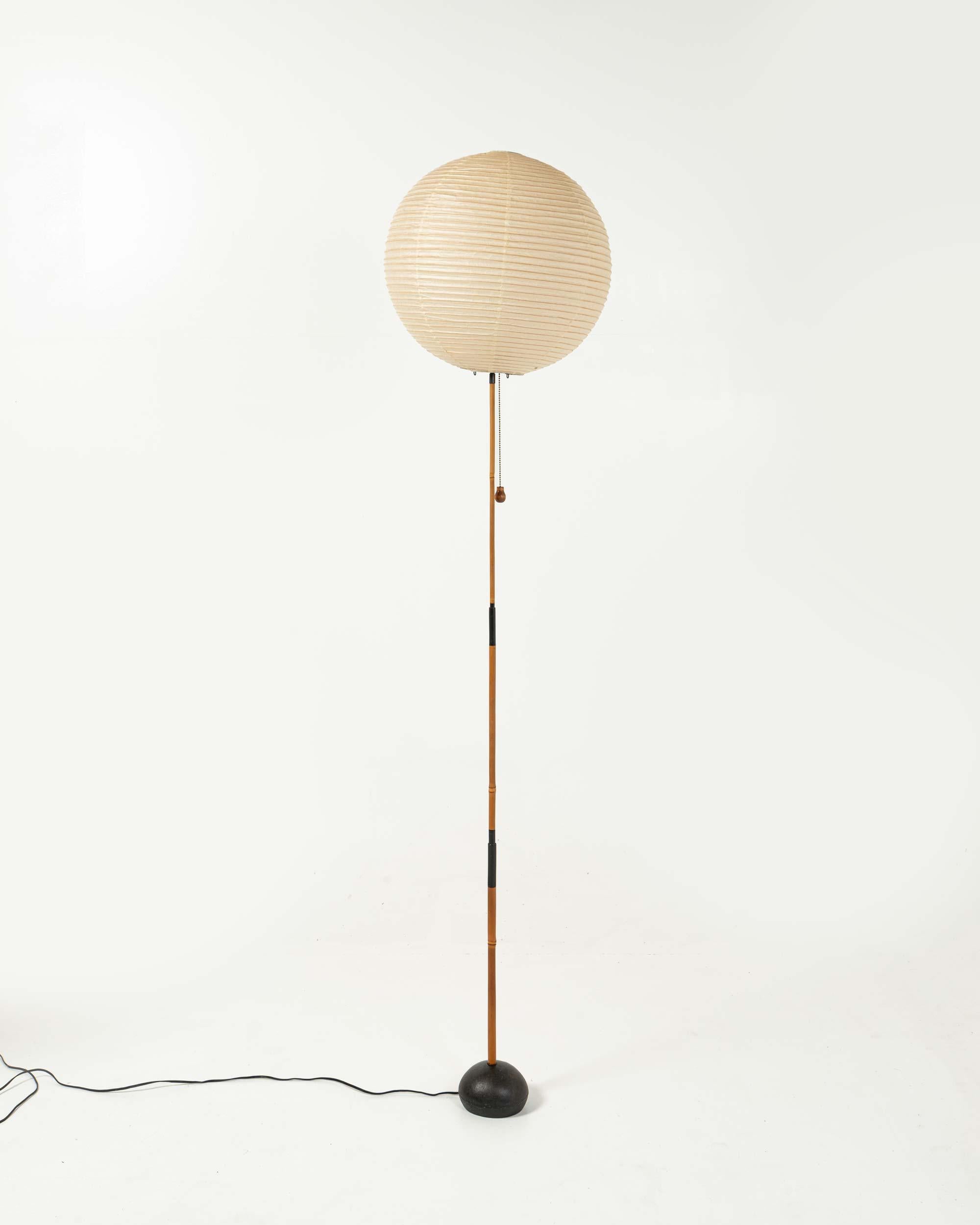 A great example of Isamu Noguchi's Light sculpture: 45A shade on BB3 base. Original paper packaging for 45A shade.

The bright red Sun and Moon stamp on the shade indicates that this is the earliest edition of Noguchi's Akari, and it has rarely been