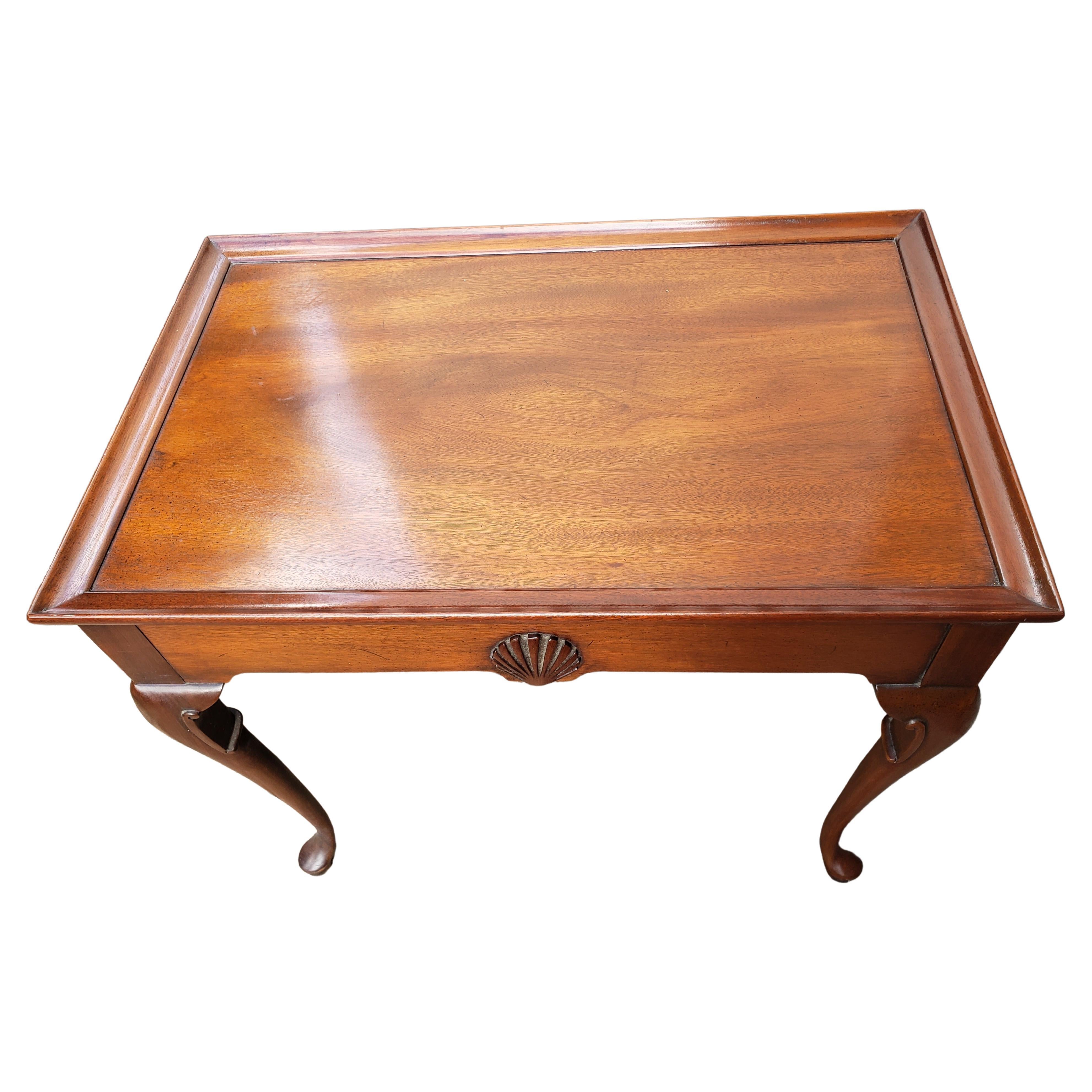 English Mahogany Queen Anne tray top tea table with pull-out slides and supported by graceful cabriole legs ending on pad feet, early 19th century. Attributed to Hickory Chair Company. Sticker partial. Measures 28