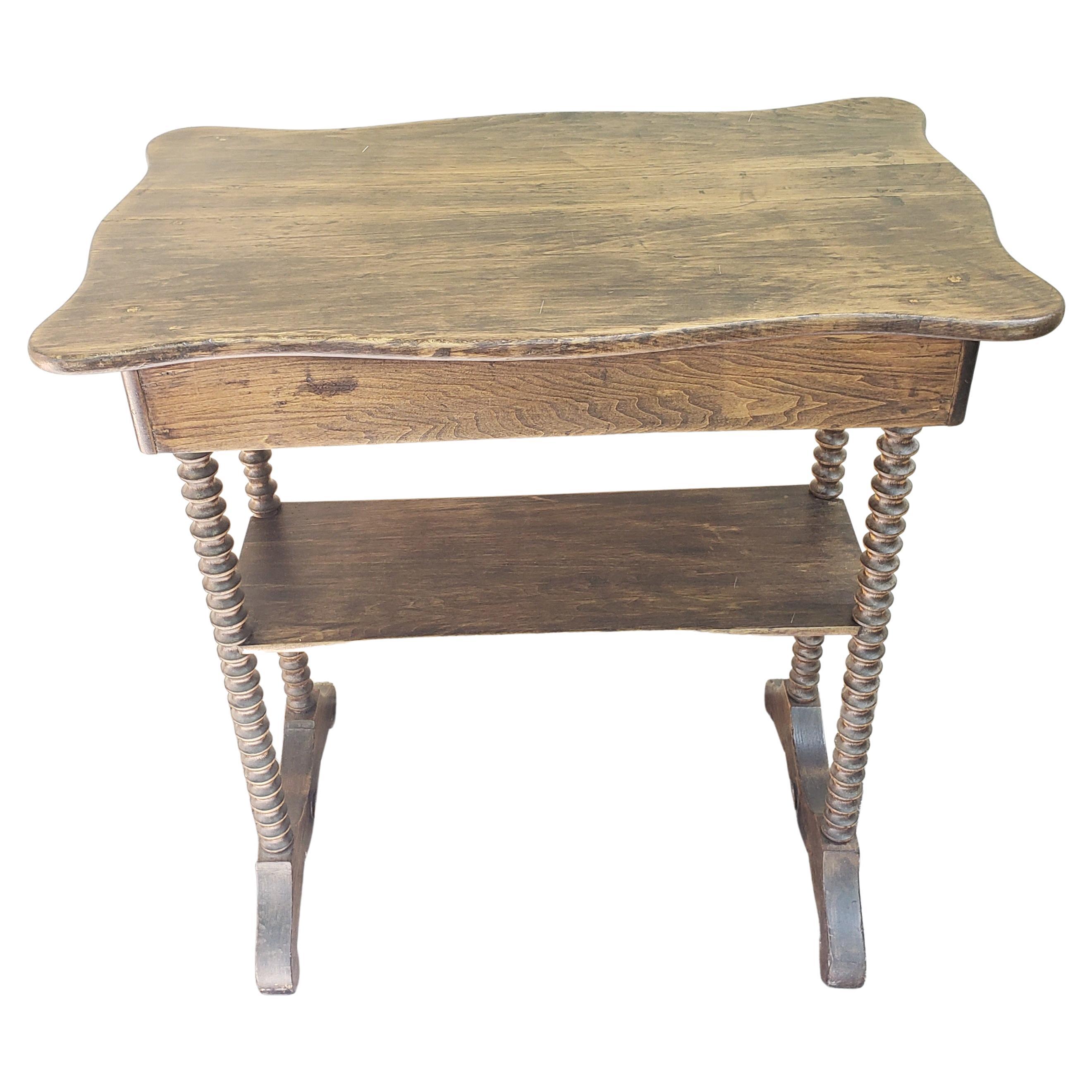 A Vintage American colonial Two tier bobbin legs table in good condition. Measures 36