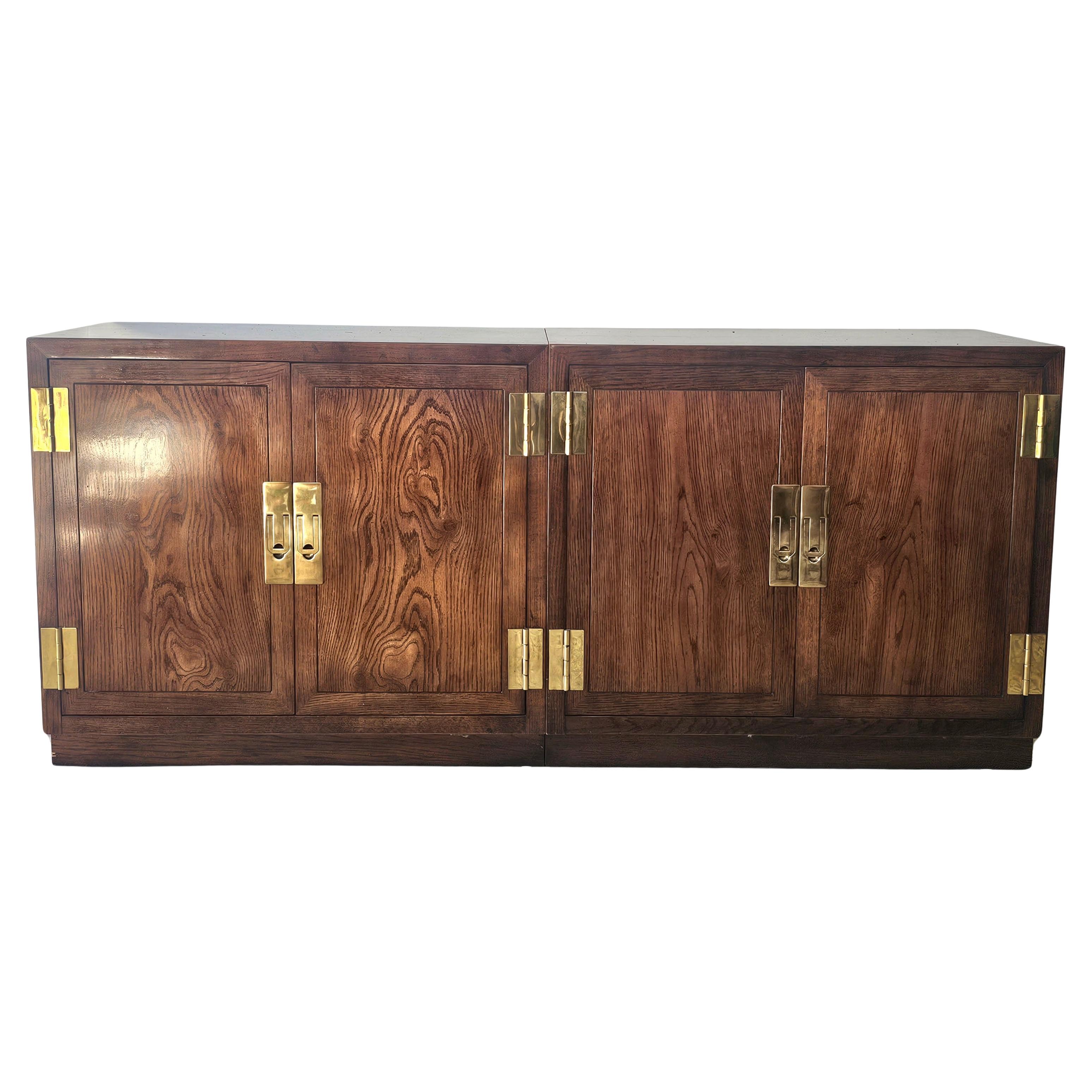 A Stunning high quality vintage three-part Henredon campaign credenza sideboard. Post mid century, circa 70s. Solid wood with select grain all around. Antiqued Brass cast brass hardware. Adjustable shelf in each piece. Each individual piece is 32