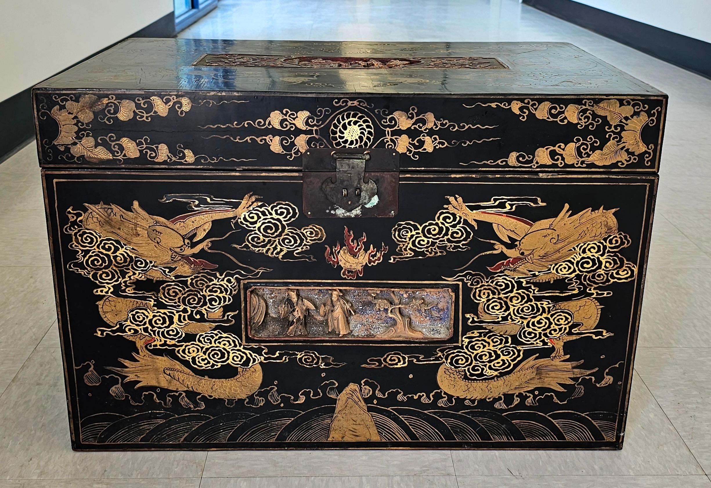 Chinese Late Qing Dynasty Ebonized and Partial Gilt Decorated Packing Trunk /  Storage chest with handles. Sides and top decorated.
Measures 27