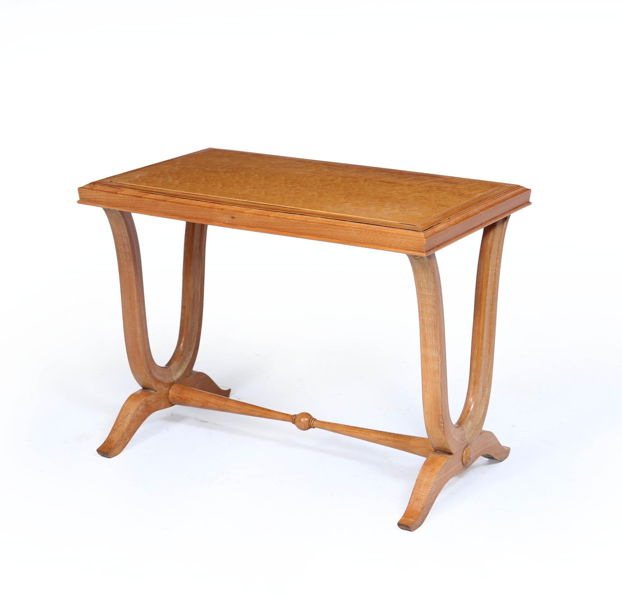 A beautifully proportioned Art Deco side table, crafted in the 1930s from bird’s-eye maple with exquisite grain detail. The rectangular top sits above gently sweeping sabre legs in the signature Art Deco style, brought together by a turned stretcher