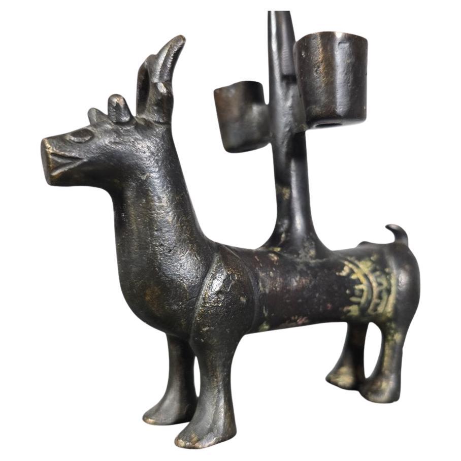 Rare pair of Gothic patinated bronze candlesticks, finely cast in the shape of stylized deer. Each animal supports a central stem serving as a candle holder.
Probably German work, attributable to the Nuremberg region, circa 14th century.

Comparable