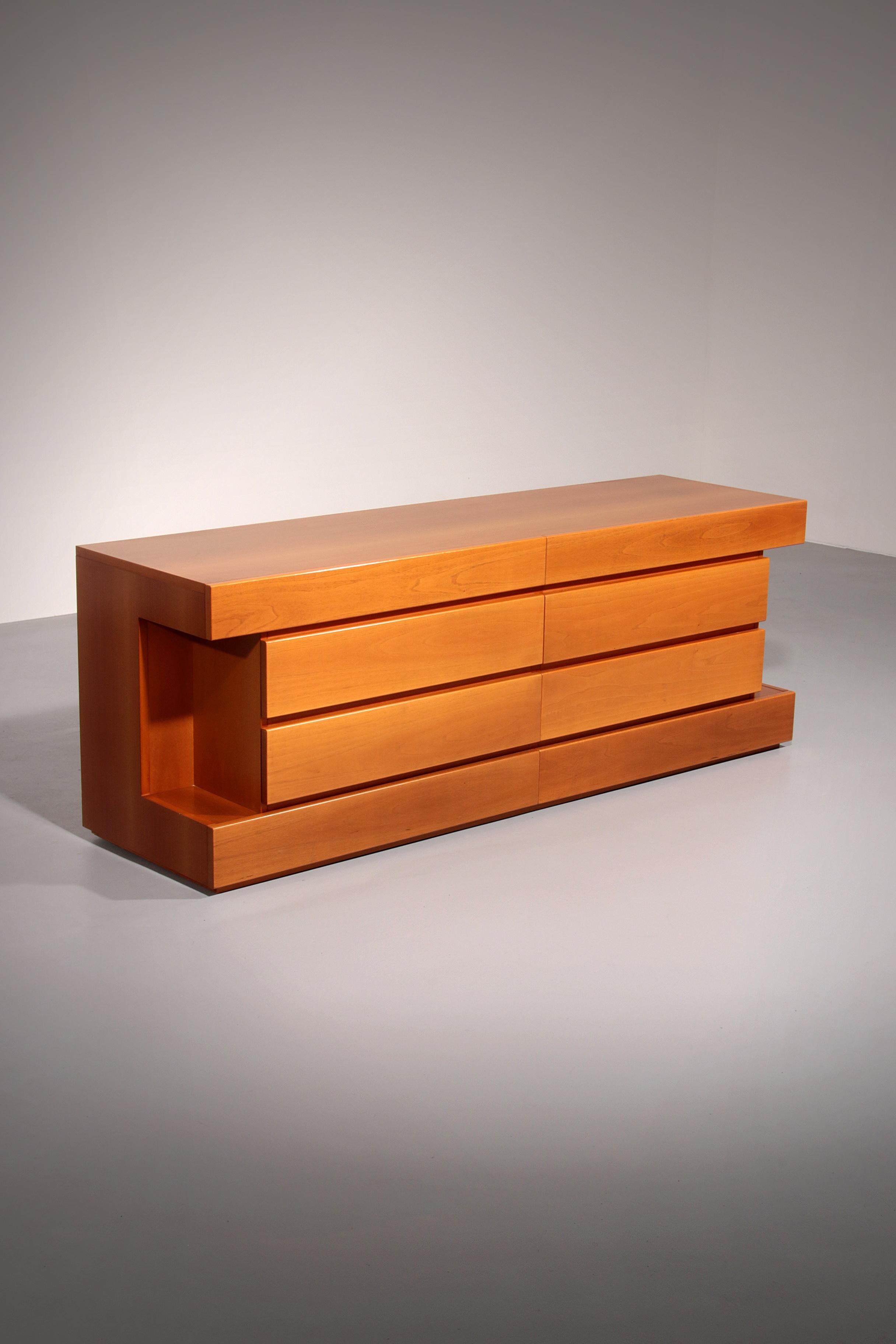 

This Postmodern custom 8-drawer dresser, made in Italy circa 1970, features a striking geometric design and a refined golden blonde birch finish.

The dresser is built to the highest standards of Italian craftsmanship, with each set of three