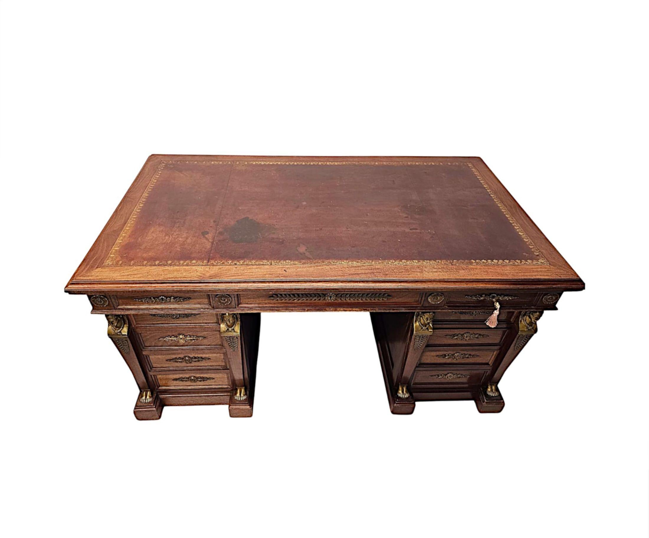 A fabulous 19th Century French Empire style well figured mahogany office desk, finely hand carved and of exceptional quality with rich patination, grain and decorated profusely with elaborate finely cast ormolu Empire Neoclassical ornamentation
