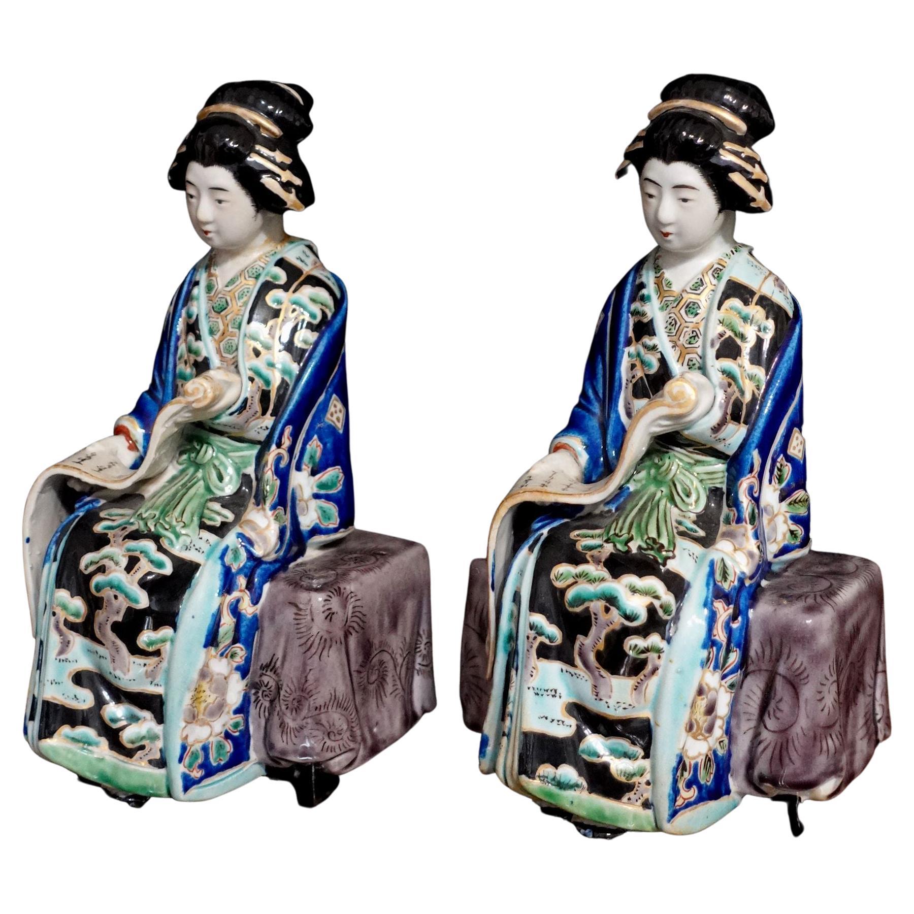 A beautiful and well-made Pair of Vantage pair of Japanese Geisha statues. They are reading the scrolls of calligraphy holding on their hands.
They can be used for display or the book ends. 
They are old but still in the new condition in the