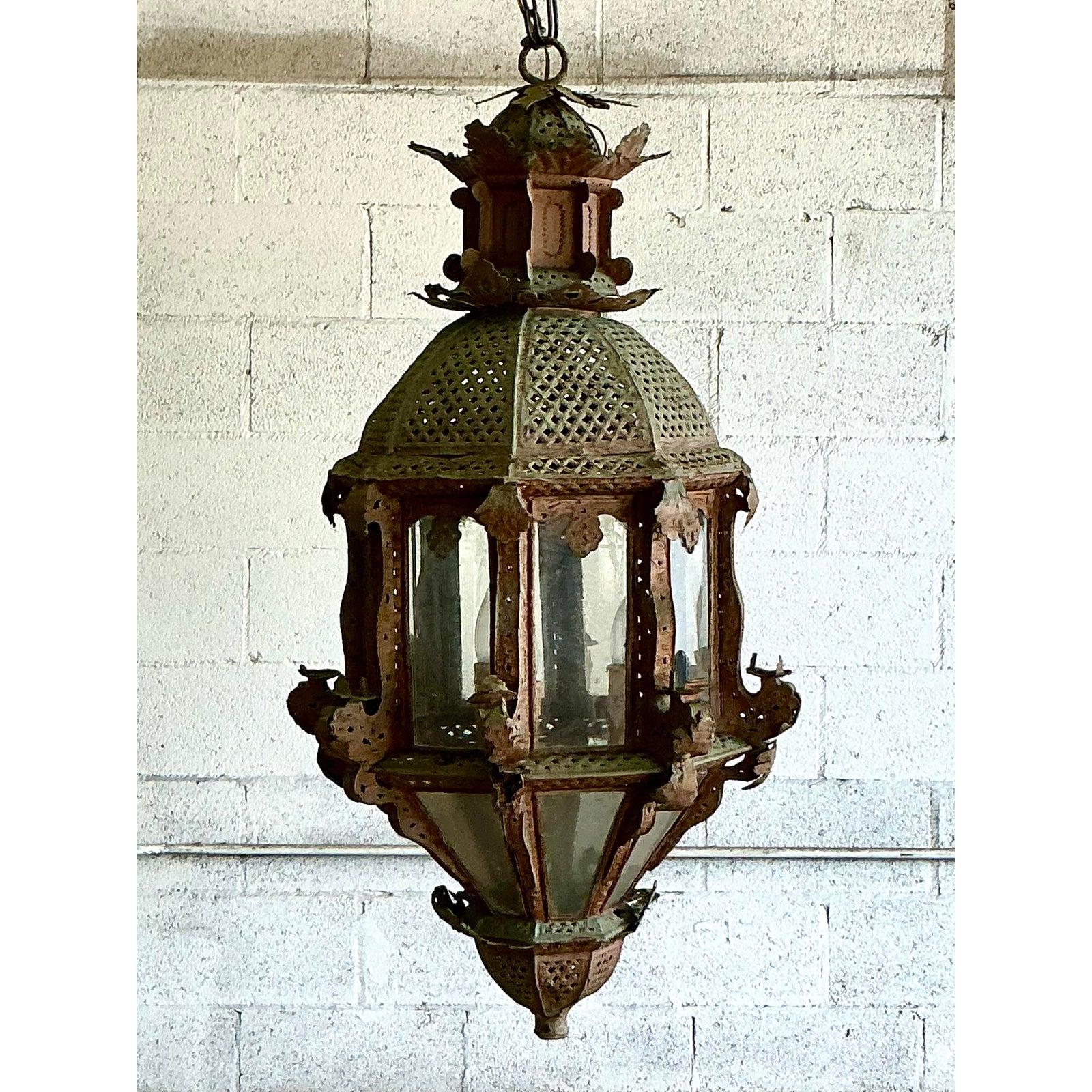 Brimming with exotic charm and Moorish artistry, this grand vintage lantern is a masterful example of handcrafted metalwork. The substantial, two-tiered form is distinguished by its intricately pierced dome, designed to cast enchanting patterns of