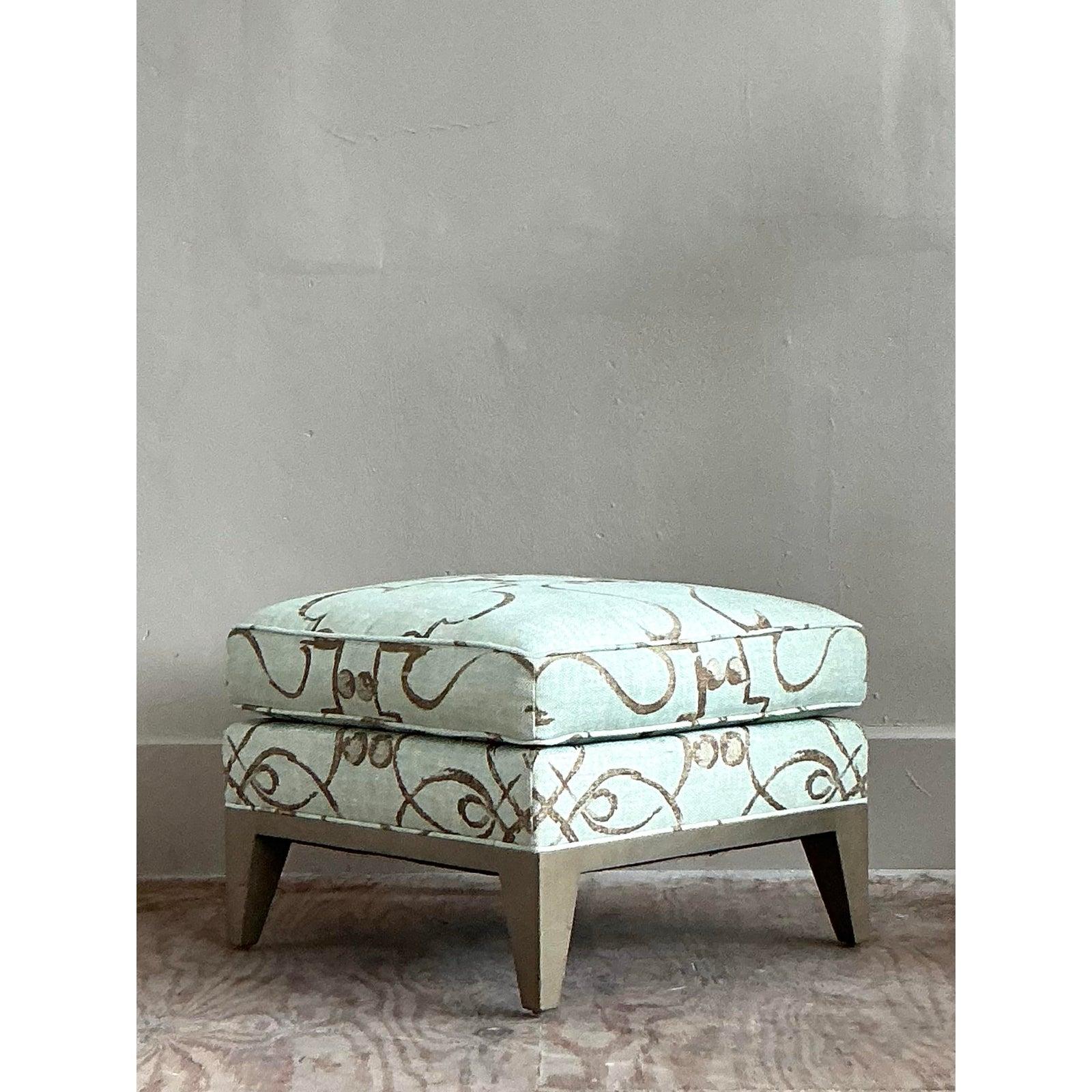 The perfect companion to its matching wingback chairs, this sophisticated ottoman from the celebrated house of Donghia is a study in versatile luxury. Its clean, cube-like form is upholstered in a stunning designer fabric, featuring an intricate