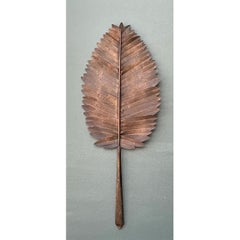 Œuvre d'art vintage en métal représentant des feuilles végétales