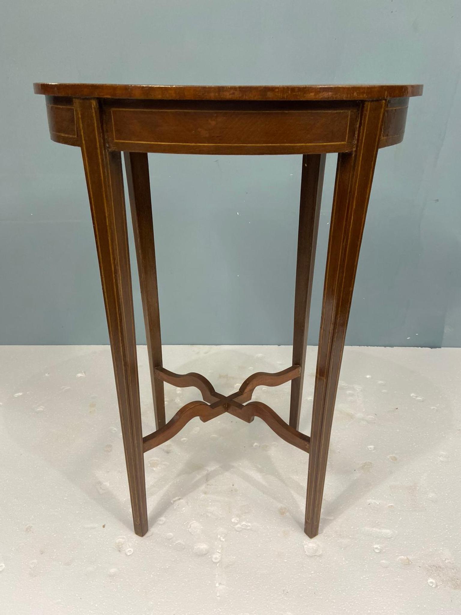 You are viewing a gorgeous Regency Revival side table
Features an oval top with parquetry designs
It stands on four slender, tapered legs, subtly fluted or inlaid to add visual interest.
Crafted from a warm-toned hardwood, likely mahogany or walnut,