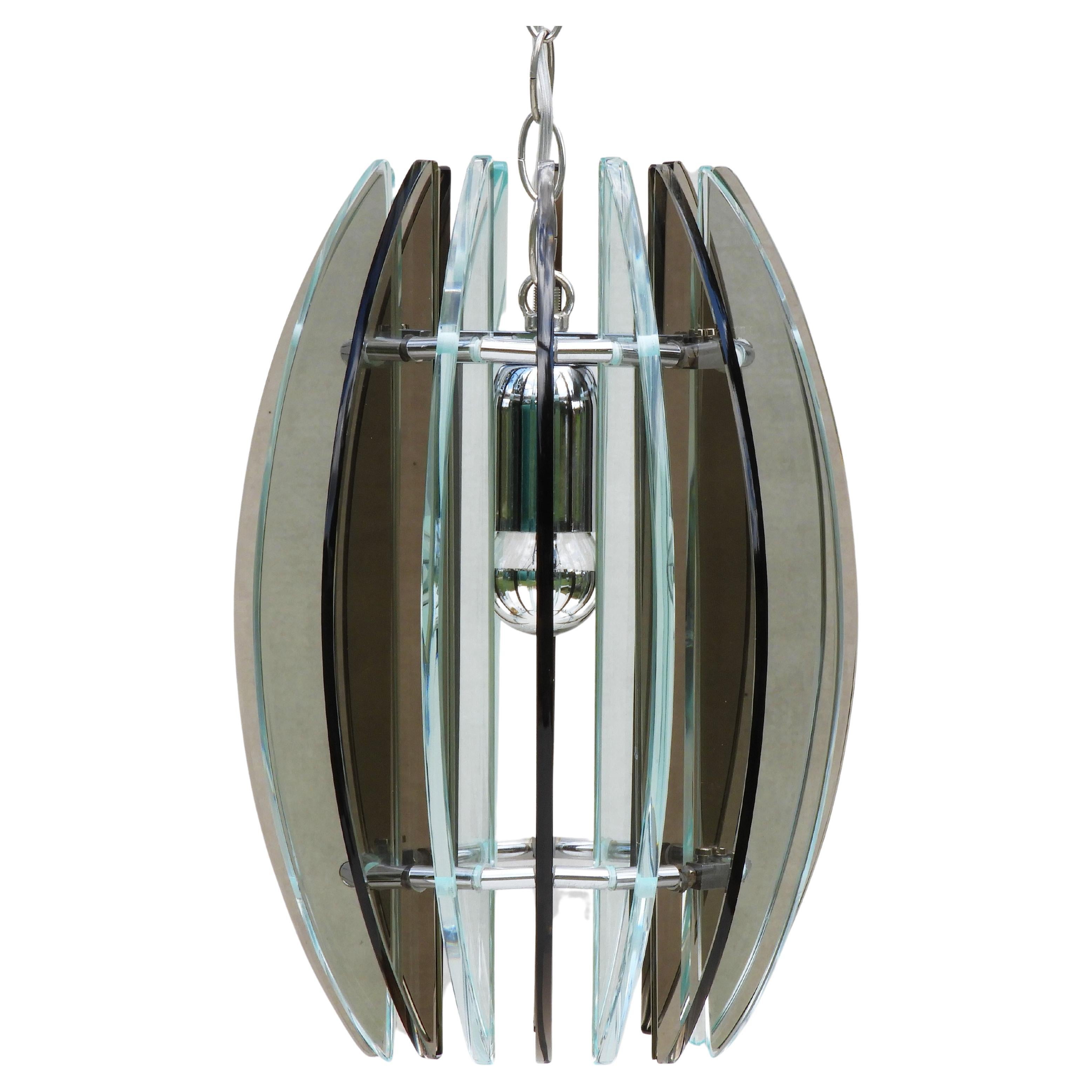Veca glass pendant light, Mid-Century Italy, C1970
Iconic Mid-century ceiling light from Italian lighting manufacturer Veca.
Sixteen alternating, smoked black and transparent glass, crescents in circular form on a chromed frame structure.
In very