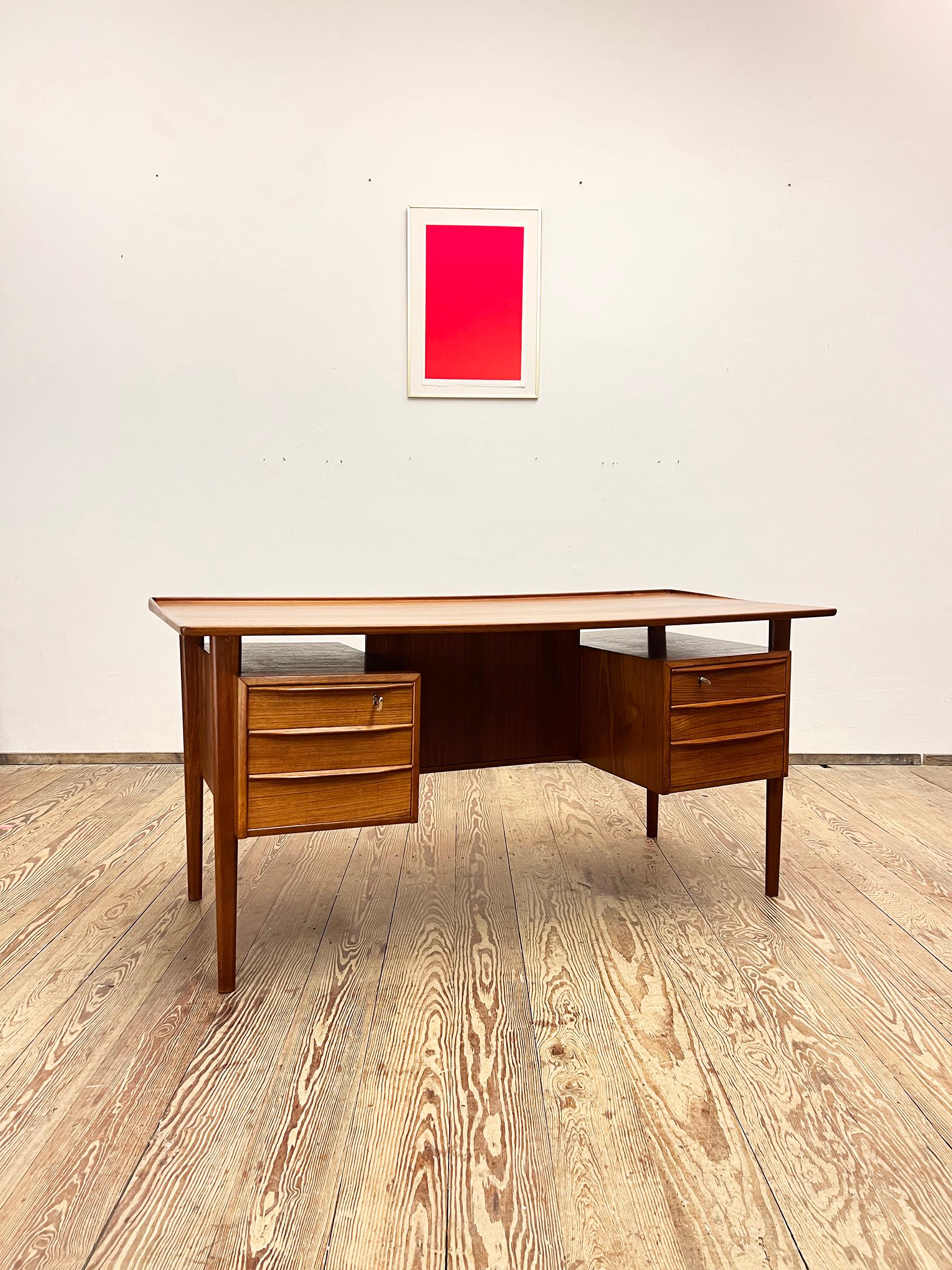 Dimensions 74 cm x 155 cm x 70 cm (Depth x Width x Height)


This free standing midcentury danish writing desk was designed by Peter Løvig Nielsen, produced by Hedensted Møbelfabrik Denmark in 1976. The table is made of teak wood and features two