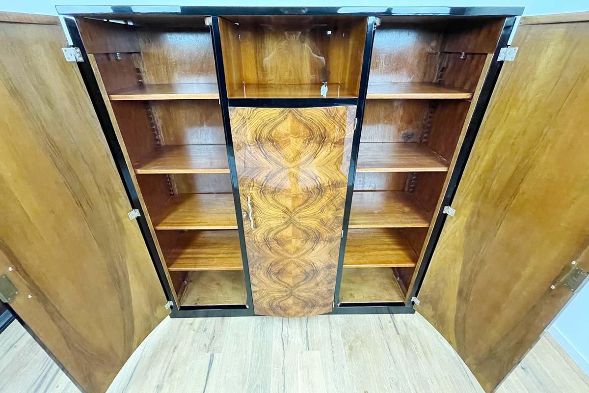 Art Deco library / highboard from Paris (Villa Victor Hugo) around 1925 with an unusual walnut. Original Art Deco furniture from a time full of life and elegance. We get all of our furniture unrestored so that we can be sure that it is really