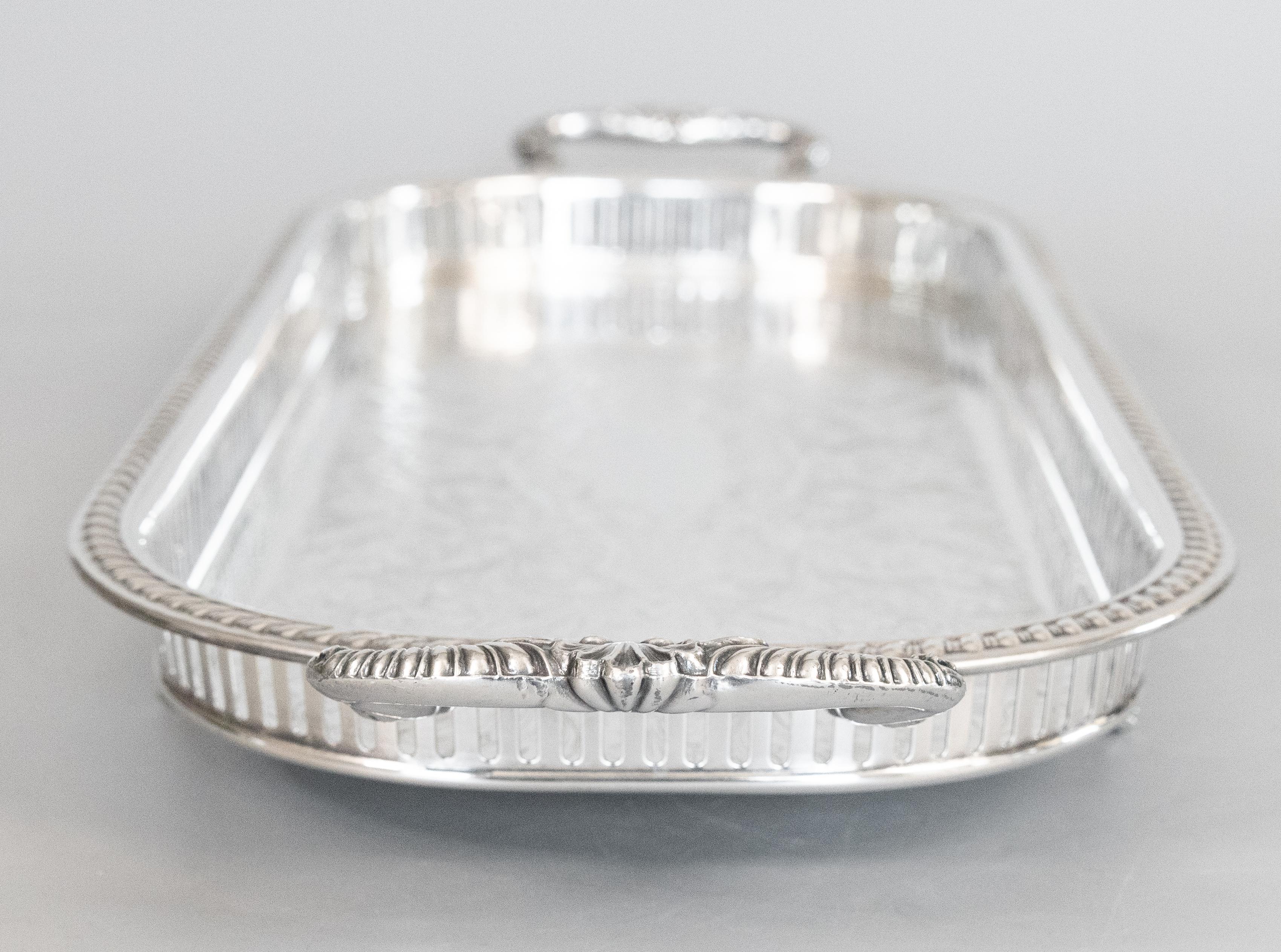 A fine vintage Mid Century silverplate footed gallery serving or barware tray with handles by Sheridan, circa 1950. Maker's mark on reverse. This gorgeous tray is a nice large size with lovely floral chasing, a pierced gallery, and ornate feet and