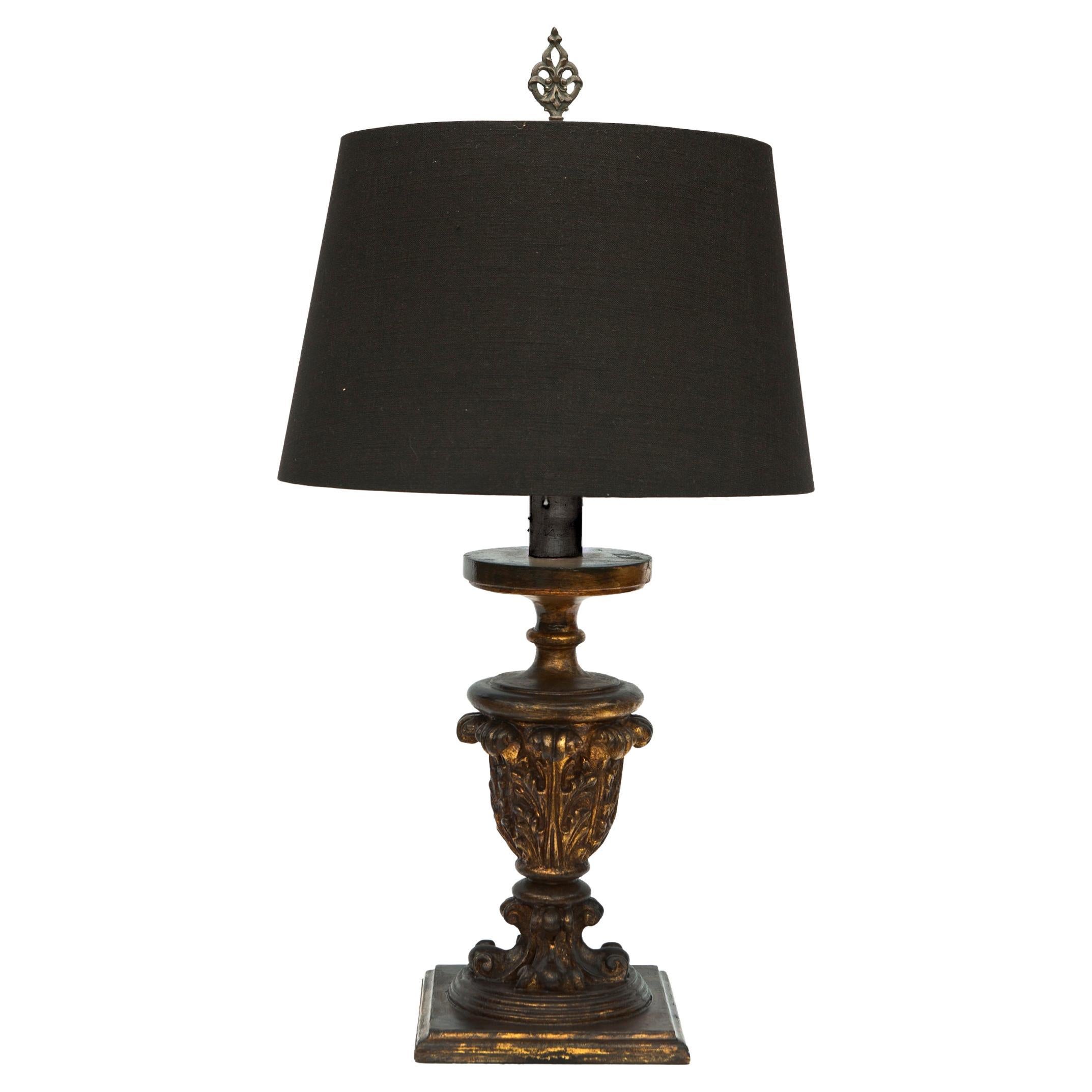 French wood table lamp, hand carved giltwood with ebony glaze over the gilt finish. Belgian linen the shade is available upon request.