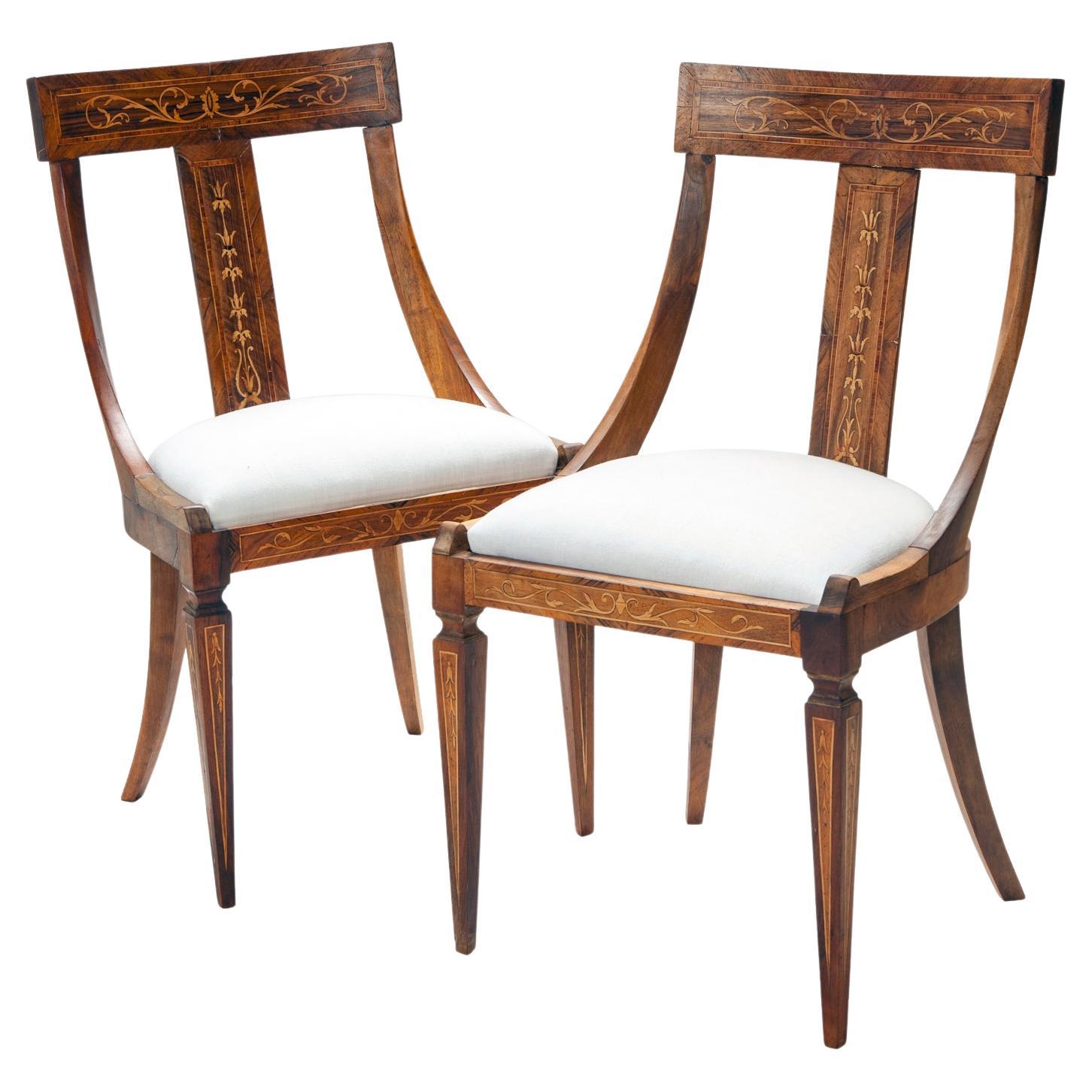 Set of four classic Biedermeier dining chairs with decorative inlay on the curved back panel & legs.
Newly upholstered drop in seats covered in in fine light weight off-white linen. 
Additional upholstery options are available upon request.
Standing