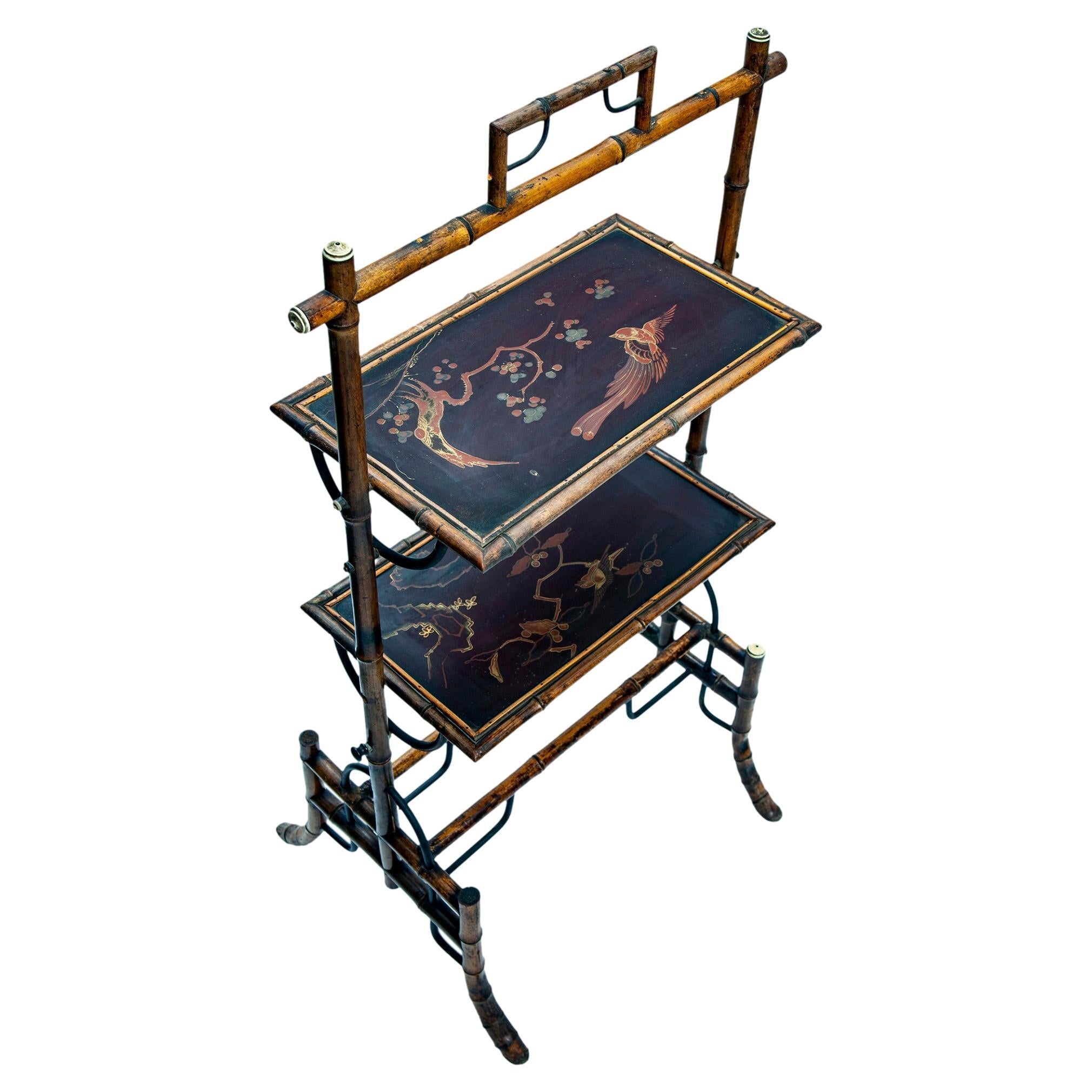 Asian bamboo tray table with handpainted with birds & branches. A handle on the top for moving around easily. The painted motif is visible on both trays.
There are two shelves to use as a side table or perhaps a drink or for hors d’oeuvres tray. The