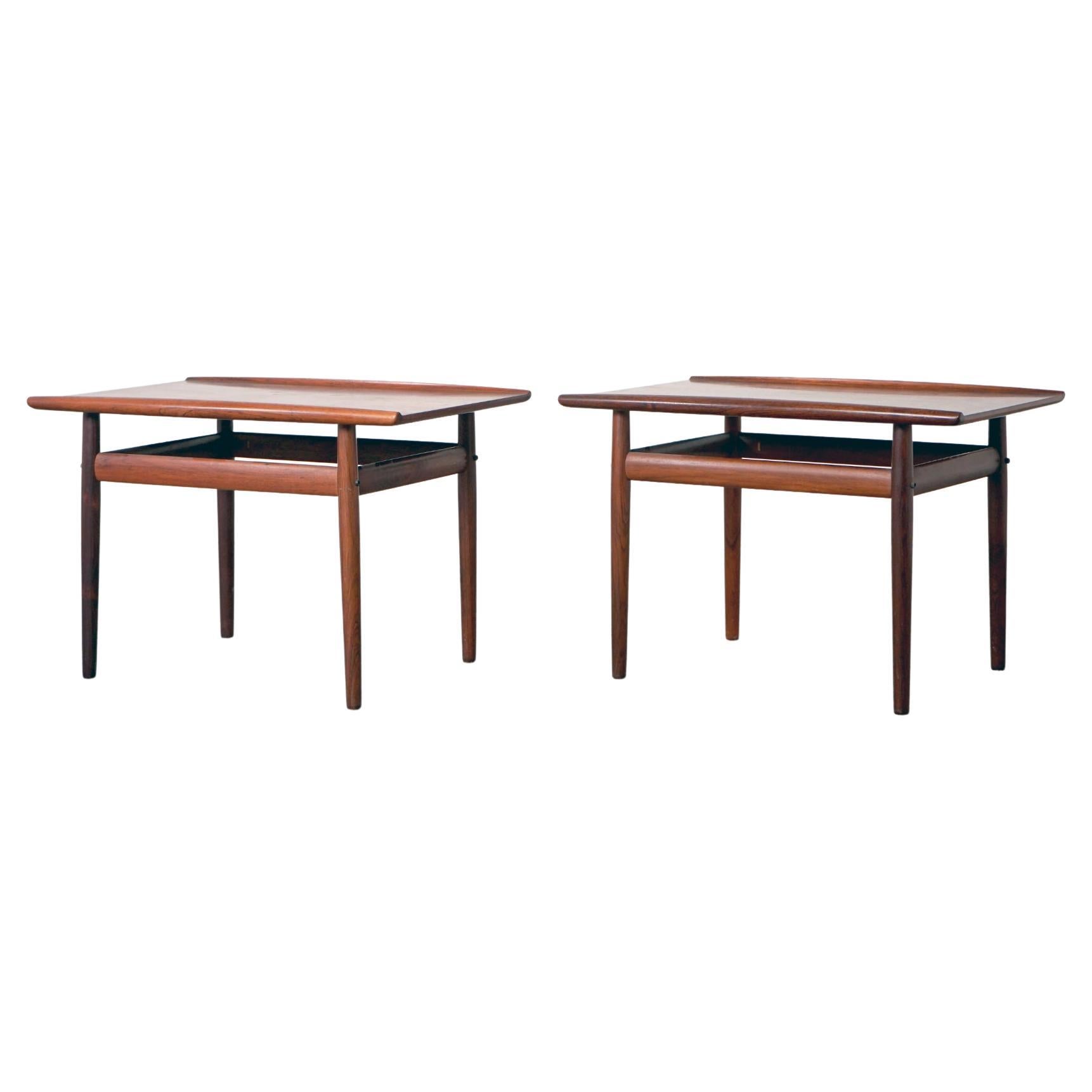 Rosewood Danish side tables by Grete Jalk for Glostrup, circa 1960's. Solid wood construction on the base and beautifully sculpted raised edges. Handsome book-matched veneer on the tops, stunning grain patterns! Underside of one table shows Glostrup