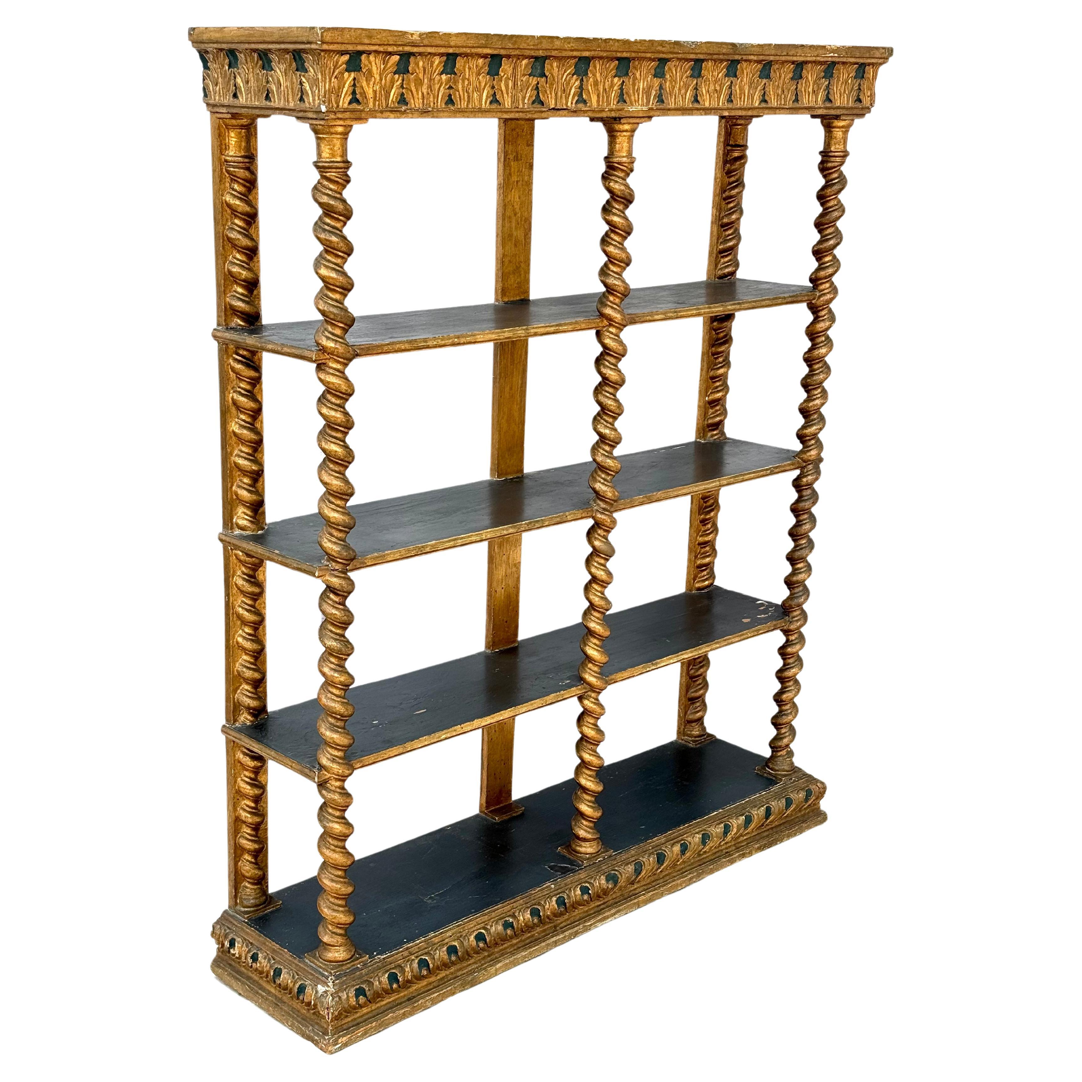 Italian Renaissance giltwood open bookcase, 19th century with antique elements, the gilt and polychrome top with carved acanthus reserves above the three fixed shelves, conjoined by the carved supports terminating at the shaped and molded base. The