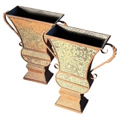 A pair of large decorative iron and mirrored urns, 20th century