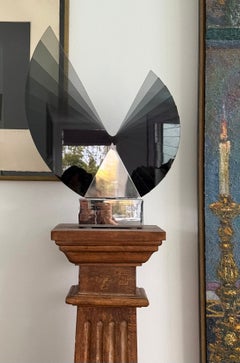 A large smoked glass and chrome sculpture by Runstadler Studios, signed, 1990