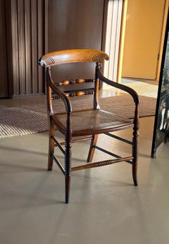Antique English wood armchair with cane seat, early 19th century