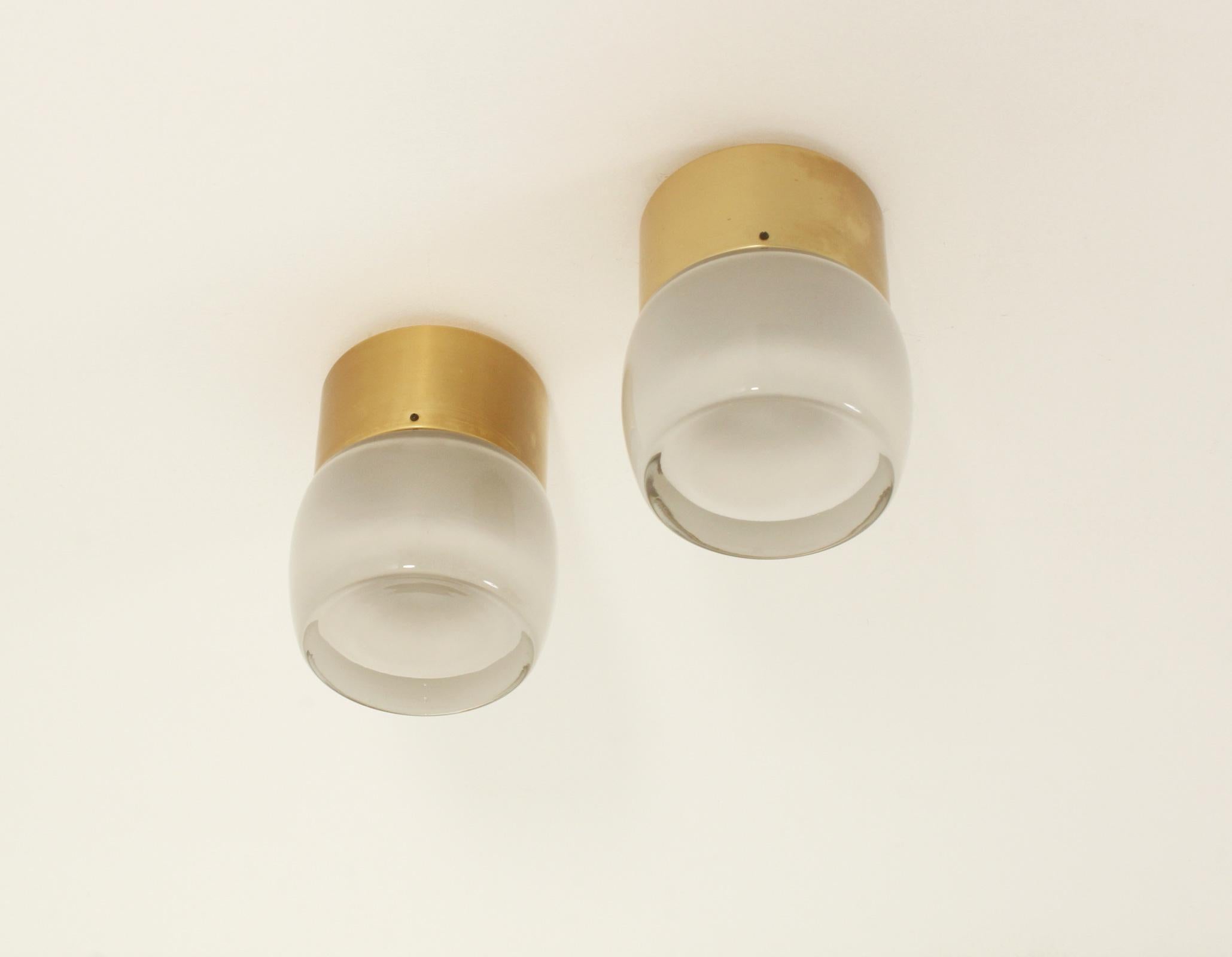Set of four large flush mounts model 7104 produced by Staff Leuchten, Germany, 1960's. Brass finished aluminum base and optical glass reflector with matte interior.
