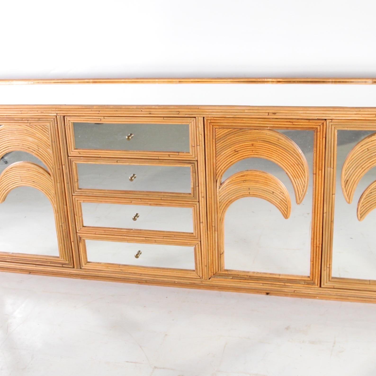 Beautiful large rattan and mirrored sideboard/credenza with palmtrees patterns.  Simple and chic unique design typical of the seventies. High quality of craftsmanship, entirely hand made. Excellent condition.