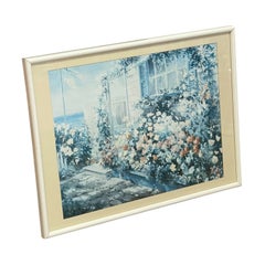 Stampa vintage che raffigura un giardino in stile cottage costiero con vista sull’oceano, incorniciata.