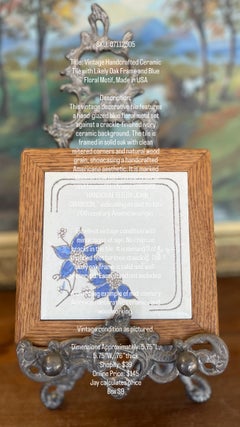 Vintage Handcrafted Ceramic Tile with Likely Oak Frame and Blue Floral Motif.