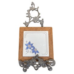 Vintage Handcrafted Ceramic Tile with Likely Oak Frame and Blue Floral Motif.