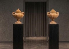 Large urn-shaped vases made of Giallo Antico marble