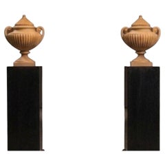 Large urn-shaped vases made of Giallo Antico marble