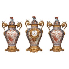 A clock set 3 pieces imari porcelain and bronze