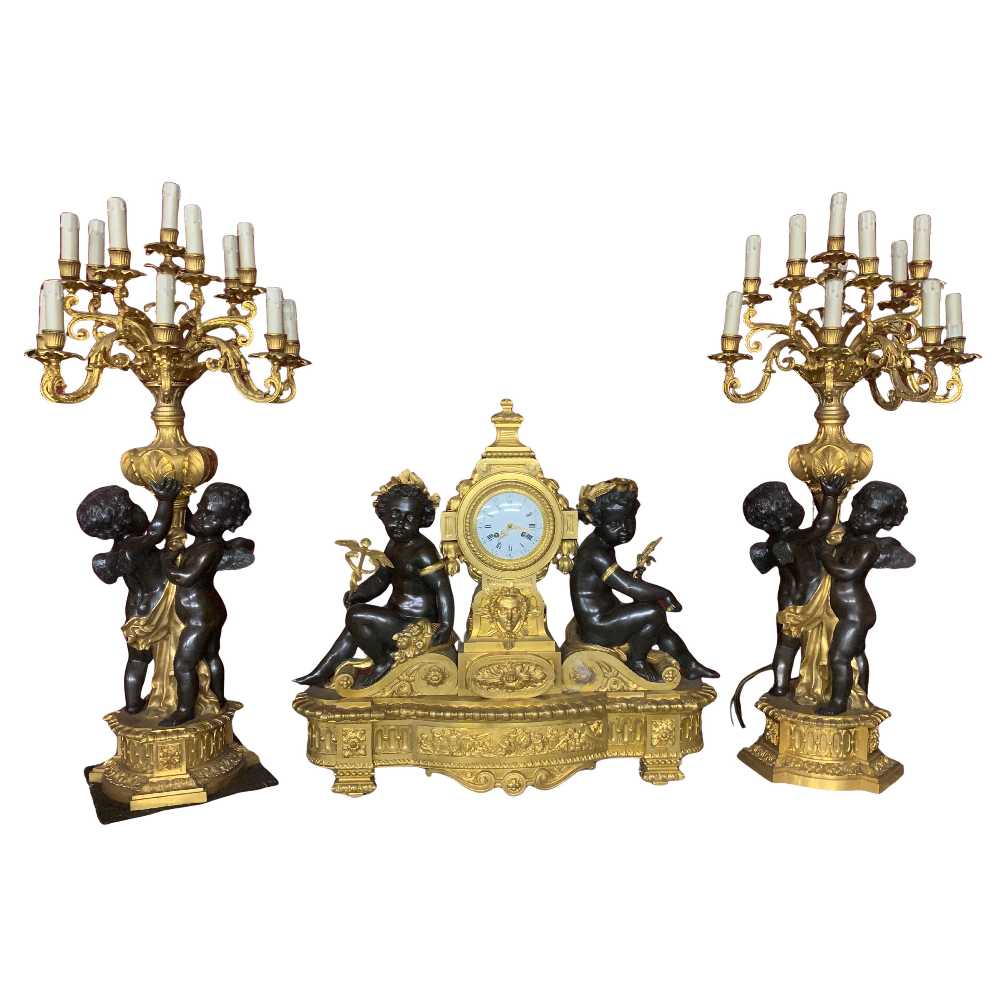 palatial  3 pieces clock set in bronze with cherub For Sale