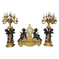 palatial  3 pieces clock set in bronze with cherub