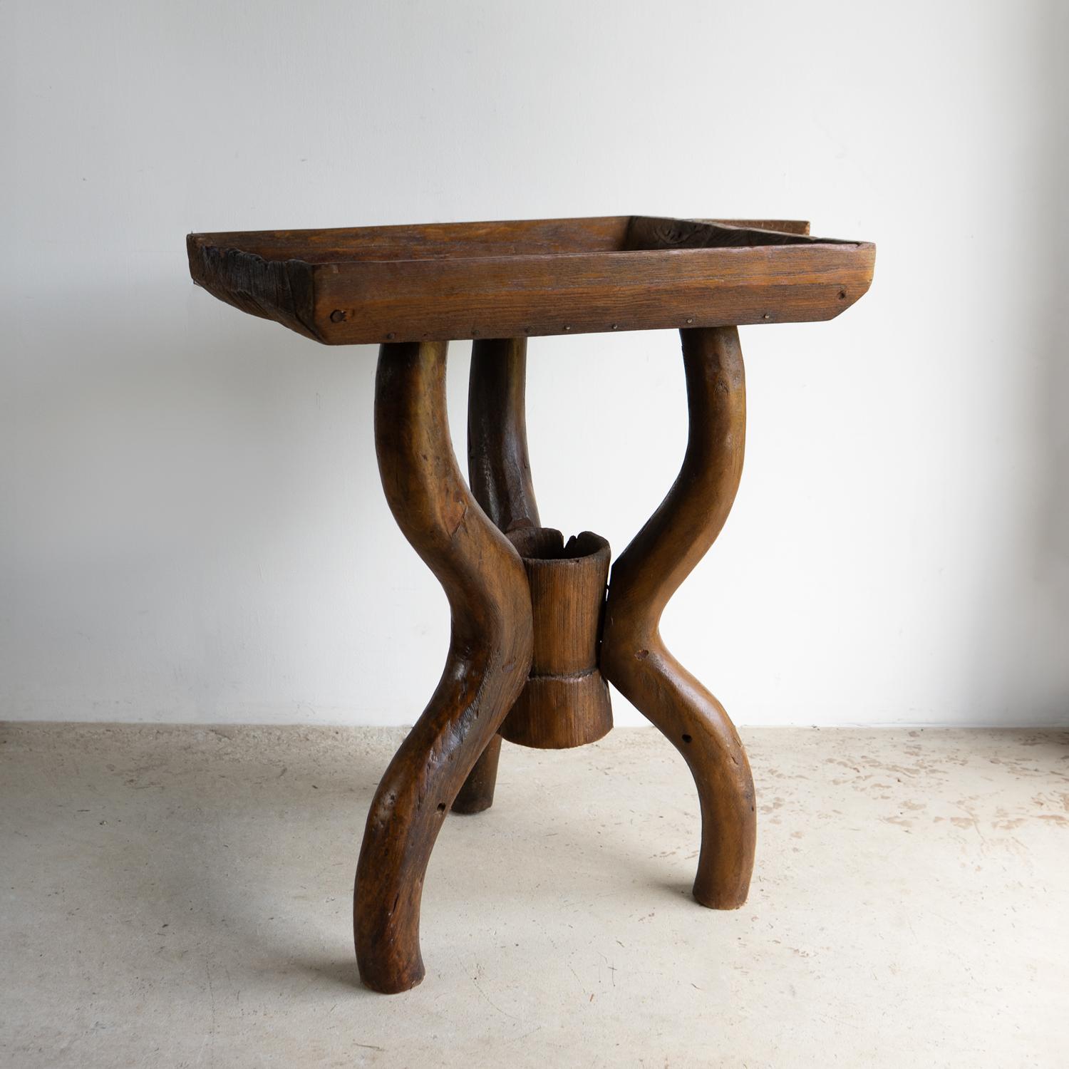 ANTIQUE SIDE/OCCASIONAL TABLE

A rustic piece constructed from an original antique 19th-century French dug-out dough trough, which has been mounted onto an organic form tripod base centred around a dug-out trunk container.

Converted to a table at