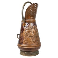 Copper umbrella stand with hammered relief of a medieval bakery, France ca. 1900