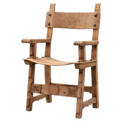 Brutalist armchair with carved rosettes and nailed wooden seat, Spain