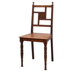 Art Deco oak side chair with carved rosette back and turned front legs, Belgium